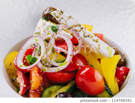 Fresh greek salad in white bowl Fresh greek salad in white bowl 114798391