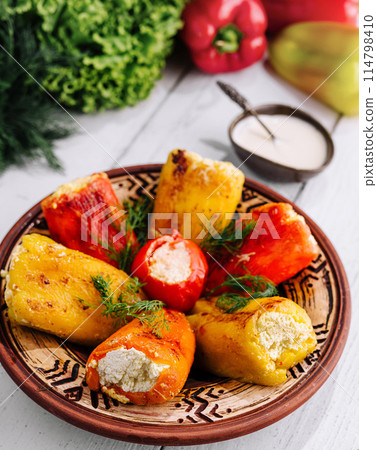 Stuffed bell peppers on rustic table 114798410