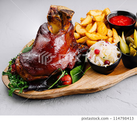 Gourmet roasted pork knuckle platter with sides 114798413