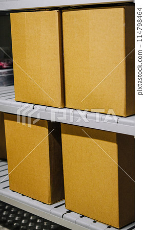 Cardboard boxes on metal shelving unit Cardboard boxes on metal shelving unit 114798464