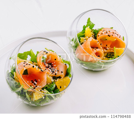 Fresh salmon salad in glass bowls Fresh salmon salad in glass bowls 114798488