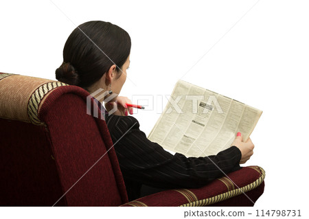 Young woman in chair reading a newspaper with an advertisement Young woman in chair reading a newspaper with an advertisement 114798731
