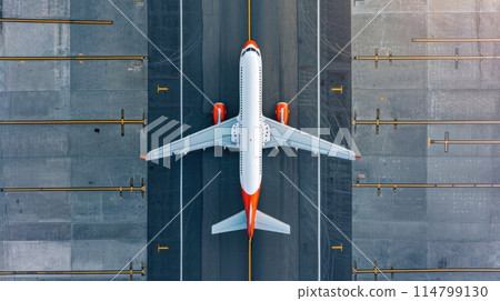 Top down view on commercial airplane docking in terminal in the parking lot of the airport apron, waiting for services maintenance, refilling fuel services after airspace lock down 114799130