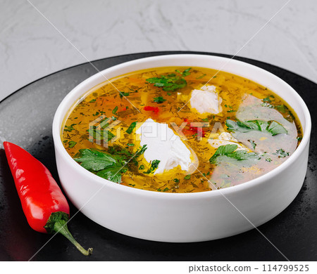 Homemade spicy soup with herbs and cream Homemade spicy soup with herbs and cream 114799525