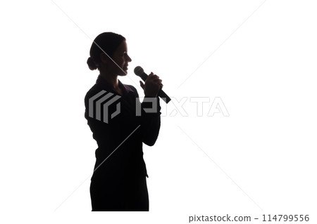 Young woman singing into the microphone Young woman singing into the microphone 114799556