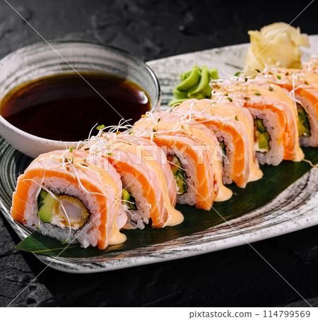 Fresh salmon sushi roll platter with dipping sauce 114799569