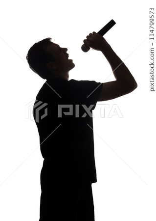 Young man singing into the microphone Young man singing into the microphone 114799573