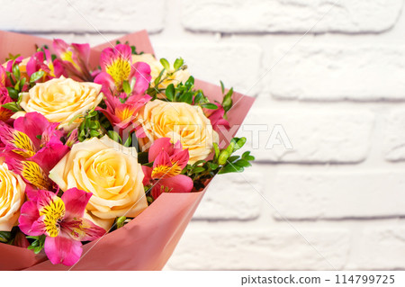 Bouquet of beautiful roses and alstroemeria on white background with copy space. Floral shop concept Bouquet of beautiful roses and alstroemeria on white background with copy space. Floral shop concept 114799725