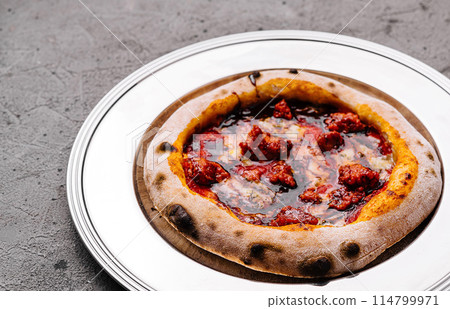 Artisan pepperoni pizza on white plate Artisan pepperoni pizza on white plate 114799971