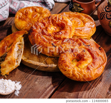 Traditional baked apple pies on wooden table 114800065