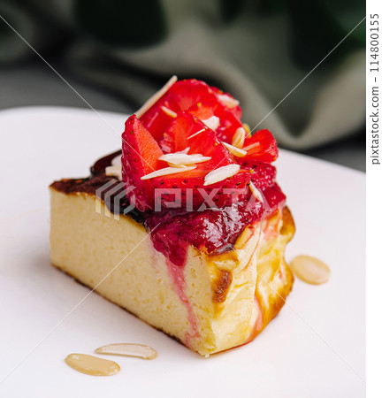 Gourmet strawberry cheesecake slice on elegant plate 114800155