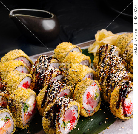 Delectable sushi platter on dark background Delectable sushi platter on dark background 114800285