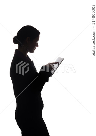 Young woman in suit shows pointer forward, side view - silhouette Young woman in suit shows pointer forward, side view - silhouette 114800302