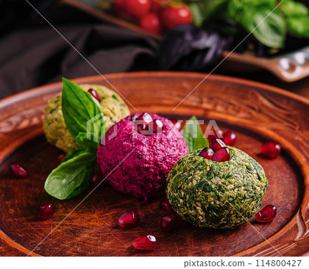 Colorful vegetarian falafel balls with pomegranate seeds Colorful vegetarian falafel balls with pomegranate seeds 114800427