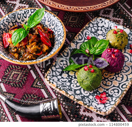 Traditional ethnic cuisine on ornate tablecloth 114800459
