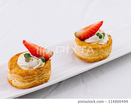 Elegant strawberry puff pastries on white plate Elegant strawberry puff pastries on white plate 114800499