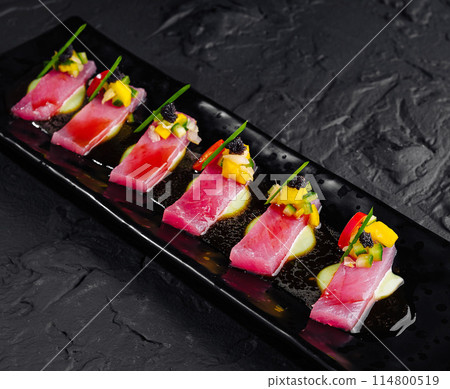 Gourmet tuna sashimi on black slate plate 114800519