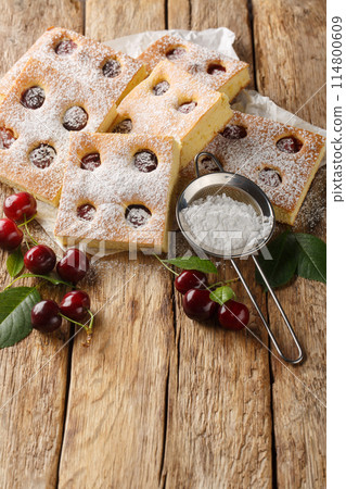 Bublanina pie fresh, juicy summer cherry enveloped in a soft sponge cake closeup on the parchment. Vertical Bublanina pie fresh, juicy summer cherry enveloped in a soft sponge cake closeup on the parchment. Vertical 114800609