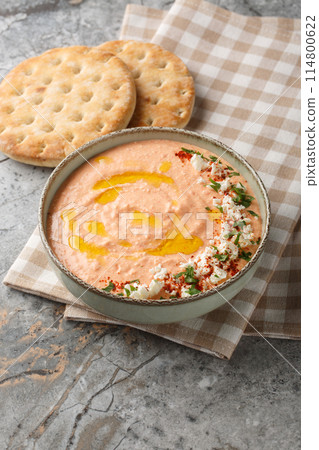 Spicy Greek Feta Dip Tirokafteri with added garlic, bell pepper, yogurt and olive oil closeup on the bowl. Vertical Spicy Greek Feta Dip Tirokafteri with added garlic, bell pepper, yogurt and olive oil closeup on the bowl. Vertical 114800622