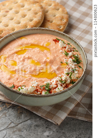 Tirokafteri Spicy Feta Dip spicy, creamy, tangy mezze from northern Greece closeup on the bowl. Vertical 114800623