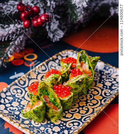 Festive spinach pancakes with salmon and caviar 114800677