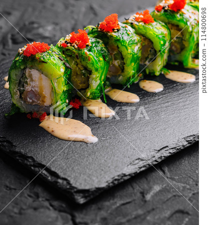 Fresh sushi roll with tobiko on slate Fresh sushi roll with tobiko on slate 114800698