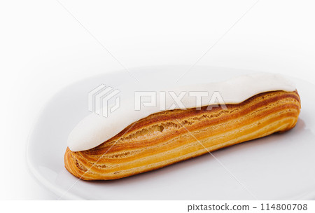 Delicious classic eclair on white plate 114800708