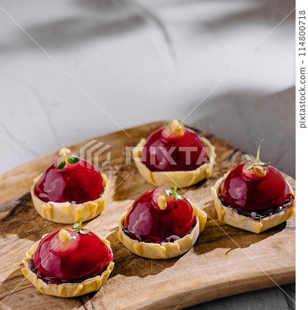 Elegant dessert assortment on wooden board Elegant dessert assortment on wooden board 114800718