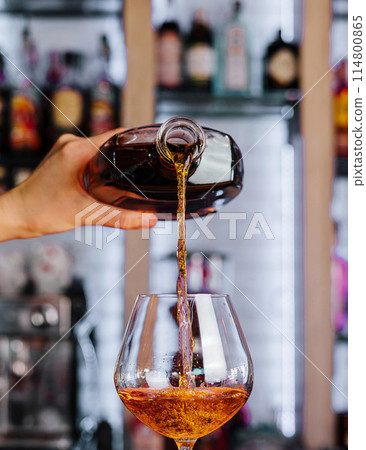 Pouring whiskey into glass at bar Pouring whiskey into glass at bar 114800865