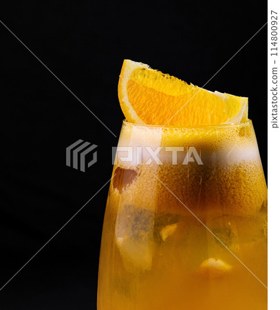 Refreshing orange cocktail on dark background Refreshing orange cocktail on dark background 114800927