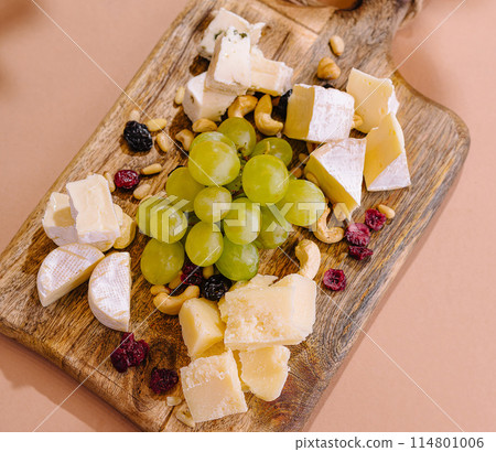 Gourmet cheese platter on wooden board Gourmet cheese platter on wooden board 114801006