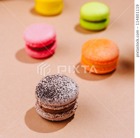 Colorful macarons on a warm beige background 114801119