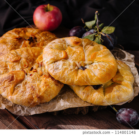 Rustic homemade apple pies on wooden table 114801148