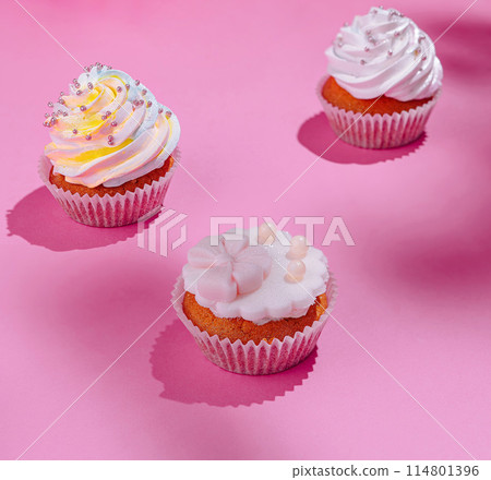 Festive cupcakes on pink background Festive cupcakes on pink background 114801396