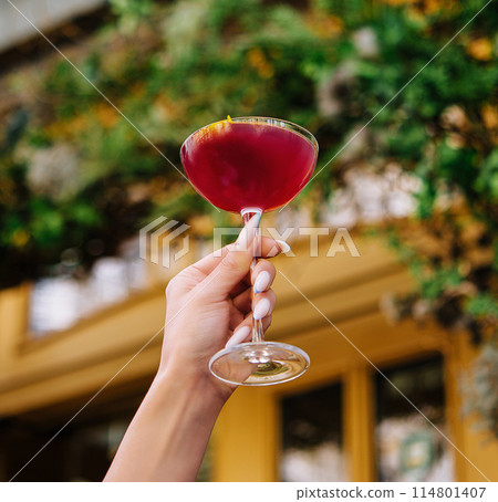 Elegant hand holding cocktail outdoors Elegant hand holding cocktail outdoors 114801407