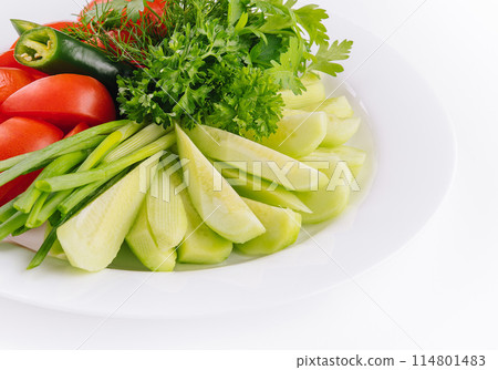Vegan plate of fresh sliced cucumbers, green onions and cherry tomatoes 114801483