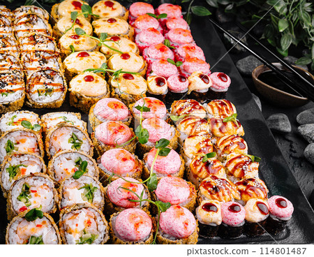 Assorted sushi platter on dark stone background Assorted sushi platter on dark stone background 114801487