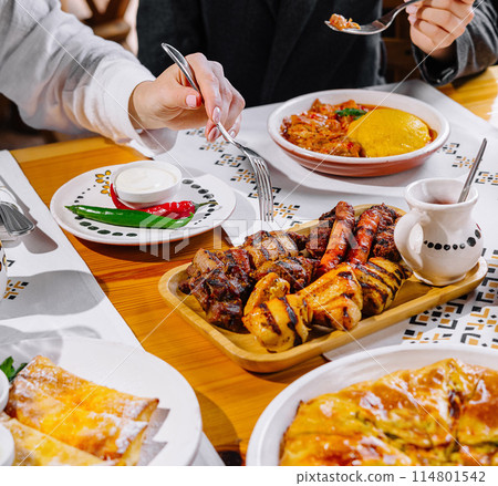 Friends enjoying a feast at a restaurant 114801542
