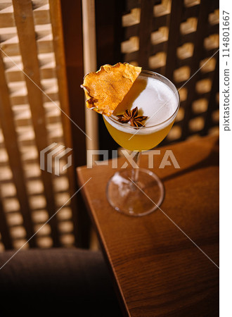 Elegant cocktail with garnish on wooden table 114801667
