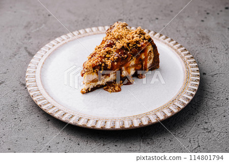 Delectable caramel cheesecake slice on plate Delectable caramel cheesecake slice on plate 114801794