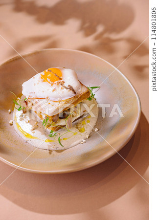 Gourmet breakfast stack with sunny side up egg 114801806