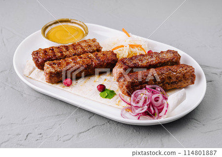 Grilled kebabs platter with sauces and salad Grilled kebabs platter with sauces and salad 114801887
