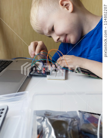 Programming for children. The boy is studying online at a robotics school for programming courses. Child learning control board coding Programming for children. The boy is studying online at a robotics school for programming courses. Child learning control board coding 114802207