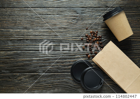 Craft coffee cups with coffee beans on a dark background Craft coffee cups with coffee beans on a dark background 114802447