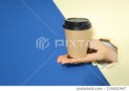 Craft cup for coffee in hand on a light background Craft cup for coffee in hand on a light background 114802467