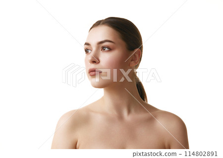 Portrait of young brunette girl with neutral make up calmly looking away against white studio background. Copy space. 114802891