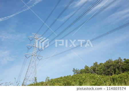 High voltage pole electric wiring distribution landscape energy engineering. Electricity energetic background with blue sky green mountain in countryside. Electric power energy engineering industrial 114803574
