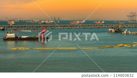 Industry landscape on sunset Engineering shipping crane depot at logistic export terminal control. Silhouette Warehouse freight background container yard loading quayside harbor port with copyspace 114803632