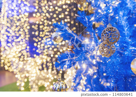 Golden Christmas Ornament sparkling blurred background. Golden glitter shiny illuminated Christmas Lights banner. Happy Holidays background for template on christmas card Gold bokeh presentation. 114803641