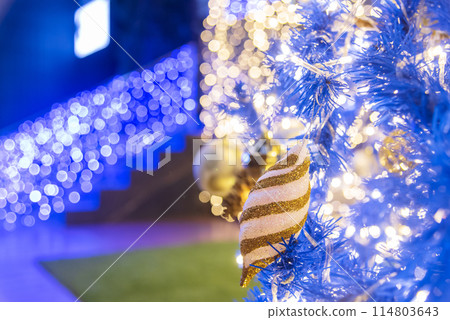 Golden Christmas Ornament sparkling blurred background. Golden glitter shiny illuminated Christmas Lights banner. Happy Holidays background for template on christmas card Gold bokeh presentation. 114803643